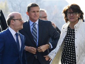 Former Trump national security adviser Michael Flynn, center, arrives at federal court in Washington, Friday, Dec. 1, 2017. Court documents show Flynn, an early and vocal supporter on the campaign trail of President Donald Trump whose business dealings and foreign interactions made him a central focus of Mueller's investigation, will admit to lying about his conversations with Russia's ambassador to the United States during the transition period before Trump's inauguration.