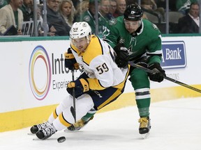 Nashville Predators defenseman Roman Josi (59), of Switzerland, and Dallas Stars center Devin Shore (17) compete for control of the puck during the first period of an NHL hockey game, Tuesday, Dec. 5, 2017, in Dallas.