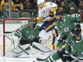 Nashville Predators left wing Viktor Arvidsson (33) jumps out of the way of a goal scoring shot by teammate Alexei Emelin, not shown, against Dallas Stars goalie Ben Bishop (30) and right wing Brett Ritchie (25) during the first period of an NHL hockey game in Dallas, Saturday, Dec. 23, 2017.