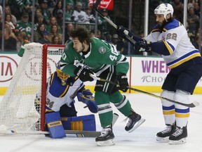 Dallas Stars left wing Remi Elie (40) is shoved by St. Louis Blues right wing Chris Thorburn (22) as goaltender Jake Allen (34) defends during the first period of an NHL hockey game in Dallas, Friday, Dec. 29, 2017.