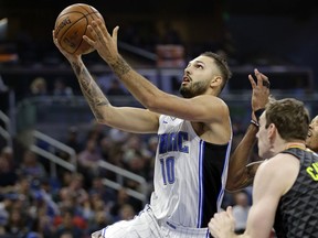 Orlando Magic's Evan Fournier (10) goes past Atlanta Hawks' Tyler Cavanaugh, right, for a shot during the first half of an NBA basketball game, Wednesday, Dec. 6, 2017, in Orlando, Fla.