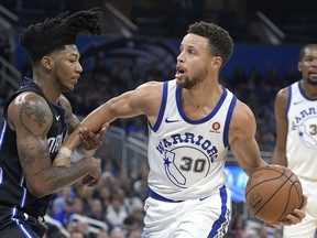 Golden State Warriors guard Stephen Curry (30) is fouled by Orlando Magic guard Elfrid Payton, left, while driving to the basket during the first half of an NBA basketball game Friday, Dec. 1, 2017, in Orlando, Fla.