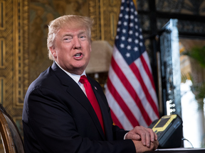 President Donald Trump talks to reporters during a Christmas Eve video teleconference with members of the mIlitary at his Mar-a-Lago estate in Palm Beach, Fla., Dec. 24, 2017.