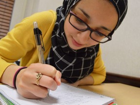 Tasneem Essader studies at a residence hall at the University of North Carolina in Chapel Hill, N.C., on Dec. 2, 2017. The Adawia Alousi Scholars program, a scholarship for Muslim women pursuing careers in science, technology, engineering and math with money from Alousi's family trust, is believed to be the first of its kind. The inaugural class of 11 recipients includes refugees, daughters of poor parents and the first in their families to go to college.