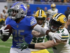 Detroit Lions running back Theo Riddick (25) is stopped by Green Bay Packers inside linebacker Jake Ryan (47) during the first half of an NFL football game, Sunday, Dec. 31, 2017, in Detroit.