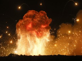 FILE - In this Wednesday, Sept. 27, 2017 file photo a powerful explosion is seen in the ammunition depot at a military base in Kalynivka, west of Kiev, Ukraine. Ukrainian officials say they have evacuated more than 30,000 people after a fire and ammunition explosions, at the military base.