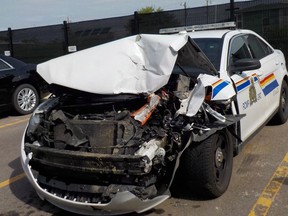 A damaged police cruiser is shown in a Red Deer RCMP handout photo. Red Deer RCMP have charged the man who is alleged to have rammed the police car on July 17 in Red Deer while driving a stolen truck, and he is scheduled to appear in court on December 19. THE CANADIAN PRESS/HO-Red Deer RCMP MANDATORY CREDIT