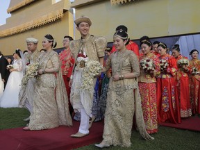 Chinese couples attend a mass wedding ceremony in Colombo, Sri Lanka, Sunday, Dec. 17, 2017. Fifty Chinese couples were married at a mass ceremony in Sri Lanka's capital to mark the 60th anniversary of diplomatic relations between the two countries and to promote the island nation as a tourist destination.