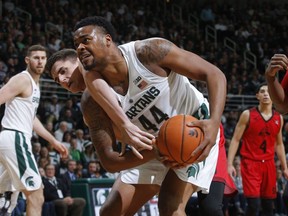 Michigan State's Nick Ward (44) and Southern Utah's Ivan Madunic wrestle for the ball during the first half of an NCAA college basketball game, Saturday, Dec. 9, 2017, in East Lansing, Mich.