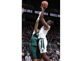 Michigan State's Jaren Jackson Jr., right, shoots against Cleveland State's Jamarcus Hairston during the first half of an NCAA college basketball game Friday, Dec. 29, 2017, in East Lansing, Mich.