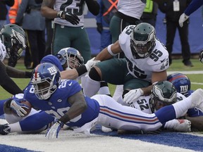 New York Giants running back Orleans Darkwa (26) dives into the endzone for a touchdown during the first half of an NFL football game against the Philadelphia Eagles, Sunday, Dec. 17, 2017, in East Rutherford, N.J.