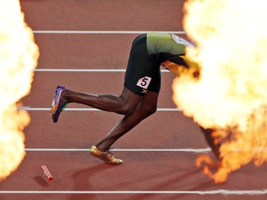 Fireworks go off as Usain Bolt falls to the track with an injury after the men's 4x100-metre relay final at the world athletics championships in London on Aug. 12.