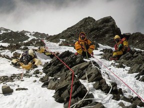 The body of Goutam Ghosh is brought down Mount Everest by two sherpas in May 2017.