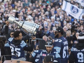 Toronto Argonauts Grey Cup MVP DeVier Posey holds the trophy at the celebration rally at Nathan Phillips Square on Tuesday, Nov. 28, 2017.