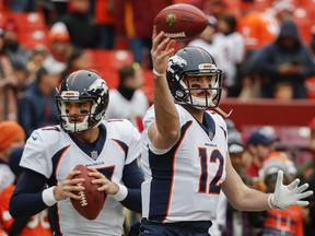 Denver Broncos quarterbacks Brock Osweiler (17) and Paxton Lynch (12) warm up before an NFL football game against the Washington Redskins in Landover, Md., Sunday, Dec 24, 2017.