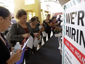 In this Tuesday, Oct. 3, 2017, photo, job seekers wait in line to apply for part-time, full-time or seasonal positions at a job fair held at Dolphin Mall in Sweetwater, Fla. On Wednesday, Dec. 6, 2017, payroll processor ADP reports how many jobs private employers added in November.