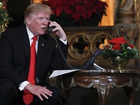 President Donald Trump speaks on the phone with children as they track Santa Claus' movements with the North American Aerospace Defense Command (NORAD) Santa Tracker on Christmas Eve at the president's Mar-a-Lago estate in Palm Beach, Fla., Sunday, Dec. 24, 2017.