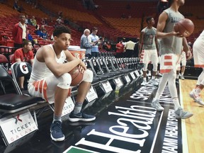 Syracuse's Matthew Moyer sits on the bench prior to the start of an NCAA college basketball game against Kansas at the HoopHall Miami Invitational tournament Saturday, Dec. 2, 2017, in Miami.