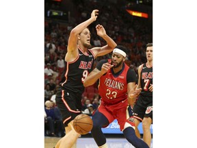 New Orleans Pelicans forward Anthony Davis (23) loses the ball out of bounds while being defended by Miami Heat center Kelly Olynyk (9) during the first half of an NBA basketball game, Saturday, Dec. 23, 2017, in Miami.