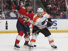 Philadelphia Flyers center Jordan Weal (40) battles in front of the net for position with Florida Panthers defenseman Michael Matheson (19) during the second period of an NHL hockey game, Thursday, Dec. 28, 2017, in Sunrise, Fla.