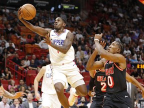 Los Angeles Clippers guard Jawun Evans (1) leaps to score past Miami Heat forward Josh Richardson (0) in the first quarter of an NBA basketball game, Saturday, Dec. 16, 2017, in Miami.
