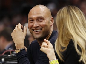 Derek Jeter, chief executive officer and part owner of the Miami Marlins and former New York Yankees player, sits courtside as the Miami Heat played against the Golden State Warriors in an NBA basketball game, Sunday, Dec. 3, 2017, in Miami.