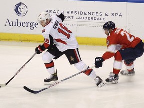 Ottawa Senators' Ryan Dzingel (18) moves the puck as Florida Panthers' Vincent Trocheck, right, defends during the first period of an NHL hockey game, Saturday, Dec. 23, 2017, in Sunrise, Fla.