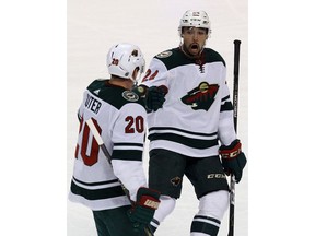 Minnesota Wild's Ryan Suter (20) celebrates with teammate Matt Dumba (24) after scoring a goal against the Florida Panthers during the first period of an NHL hockey game, Friday, Dec. 22, 2017, in Sunrise, Fla.