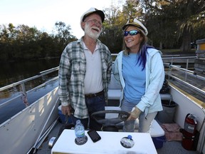 In a Thursday, Nov. 16, 2017 photo, Capt. Tom O'Lenick, the captain of Captain Tom's Custom Charters, left, laughs with Debbie Walters, right, who will be taking over as the captain of the charter boat which has been providing local river tours since Nov. 1983, as they dock after a three hour tour at the Ocala Boat Basin east of Ocala, Fla. O'Lenick will be retiring from the area soon and heading to Venice, Fla. and providing tours on the Peace and Myakka Rivers, after providing local river tours for the past 34 years. [Bruce Ackerman/Star-Banner via AP)