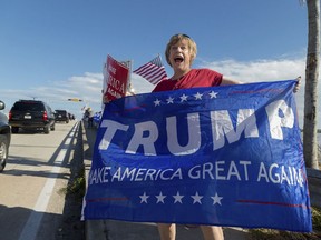 Mary Jude Smith cheers for President Donald Trump as his motorcade passes by on Southern Blvd. enroute to his Mar-a-Lago estate from Trump International Golf Club, Thursday, Dec. 28, 2017, in West Palm Beach, Fla.