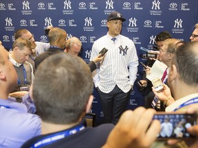 New Yankee Giancarlo Stanton answers questions for the media during the Major League Baseball winter meetings in Orlando, Fla., Monday, Dec. 11, 2017.