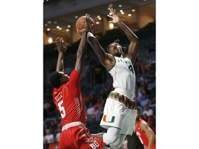 Miami guard Lonnie Walker IV (4) goes up for a shot against Boston University guard Walter Whyte (5) during the first half of an NCAA college basketball game, Tuesday, Dec. 5, 2017, in Coral Gables, Fla.