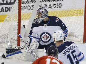 Florida Panthers defenseman Mark Pysyk (13) scores a goal against Winnipeg Jets goalie Eric Comrie (1) during the first period of an NHL hockey game Thursday, Dec. 7, 2017, in Sunrise, Fla.