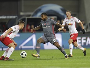 Besiktas' Jeremain Lens, center, goes past Leipzig's Willi Orban, left, and Diego Demme during the Champions League Group G soccer match between RB Leipzig and Besiktas JK in Leipzig, Germany, Wednesday, Dec. 6, 2017.