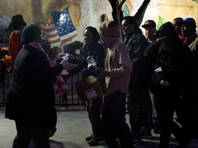 Homeless people wait in line for a meal served by a community organization outside Our Lady Queen of Angels Catholic Church Thursday, Sept. 21, 2017, in Los Angeles. A homeless crisis of unprecedented proportions is rocking the West Coast, and its victims are being left behind by the very things that mark the region's success: soaring housing costs, rock-bottom vacancy rates and a roaring economy that waits for no one.