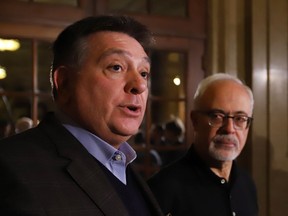 Ontario Finance Minister Charles Sousa, left, talks to reporters as Quebec Finance Minister Carlos Leitao looks on before they join their federal, provincial and territorial counterparts for dinner in Ottawa, Sunday, December 10, 2017.