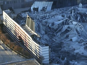 FILE - In this Nov. 20, 2017, file photo, a section of the stadium remains standing after the implosion of the Georgia Dome in Atlanta.