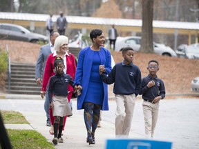 Atlanta mayoral candidate Keisha Lance Bottoms and her family prepare to enter the gym of Fickett Elementary School  to vote during the Atlanta mayoral run-off election, Tuesday, Dec. 5, 2017 in Atlanta.  Voters are deciding between Bottoms and Mary Norwood.