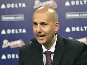 FILE - In this Oct. 1, 2015, file photo, Atlanta Braves general manager John Coppolella speaks during a news conference at Turner Field in Atlanta. The former Braves general manager apologized Tuesday, Dec. 5, 2017, for rules violations that led to him being banned from baseball for life, saying he's "disgraced and humbled" by his actions