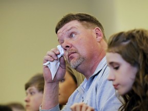 David Million wipes a tear while listening to his fiancee Kim Silvers speak at during a graduation ceremony from the Appalachian Judicial Circuit family drug court program in Ellijay, Ga., Tuesday, April 11, 2017. One of the most dramatic increases of children being taken into foster care has been in Georgia, where the foster care population soared from about 7,600 in September 2013 to more than 13,300 this spring.