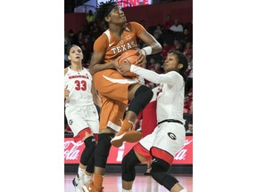 Texas forward Jordan Hosey goes up to shoot as Georgia guard Gabby Connally, right, gets her hand on the ball during the first half of an NCAA college basketball game, Sunday, Dec. 3, 2017, in Athens, Ga.