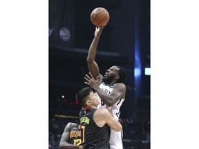 Brooklyn Nets forward DeMarre Carroll (9) shoots over Atlanta Hawks forward Ersan Ilyasova (7) in the first half of an NBA basketball game Monday, Dec. 4, 2017, in Atlanta.