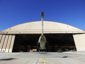 FILE - In this Oct. 30, 2014 file photo, the tail of a C5 Galaxy aircraft sticks out the door of Building 125 at Robins Air Force Base in Warner Robins, Ga.  Radio interference from a farm's massive metal crop-watering structure is causing havoc for air traffic in the sky over Georgia, federal authorities said in a lawsuit filed this week. The irrigation structure is on a south Georgia farm where the Federal Aviation Administration has a radio transmitter to relay signals that keep aircraft on course, according to the federal lawsuit.