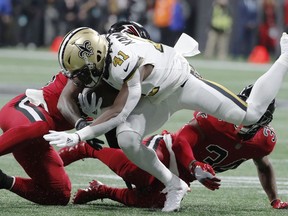 Atlanta Falcons middle linebacker Deion Jones (45) hits New Orleans Saints running back Alvin Kamara (41) during the first half of an NFL football game, Thursday, Dec. 7, 2017, in Atlanta.