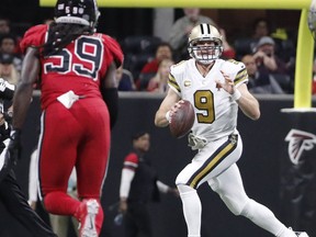 New Orleans Saints quarterback Drew Brees (9) runs out of the pocket as Atlanta Falcons outside linebacker De'Vondre Campbell (59) pursues during the first half of an NFL football game, Thursday, Dec. 7, 2017, in Atlanta.