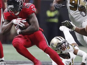 New Orleans Saints free safety Vonn Bell (48) Atlanta Falcons running back Tevin Coleman (26) runs past during the second half of an NFL football game, Thursday, Dec. 7, 2017, in Atlanta.