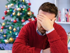 Sad man feeling negative emotions  and alone during christmas