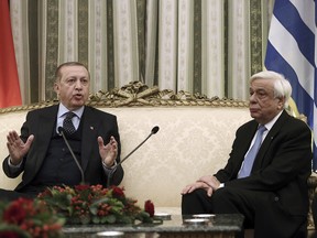 Greece's President Prokopis Pavlopoulos, right, listen to Turkey's President Recep Tayyip Erdogan, left, in Athens, Thursday, Dec. 7, 2017.