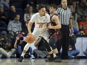 Loyola of Chicago guard Clayton Custer (13) plays tight defense against Florida guard Chris Chiozza (11) during the first half of an NCAA college basketball game in Gainesville, Fla., Wednesday, Dec. 6, 2017.