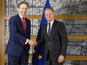 European Council President Donald Tusk, right, shakes hands with the chair of the Eurogroup Jeroen Dijsselbloem ahead of a meeting of eurozone finance ministers at the Europa building in Brussels on Monday, Dec. 4, 2017. Eurozone finance ministers meet Monday to elect a new president for the club of 19 nations that share the euro currency.